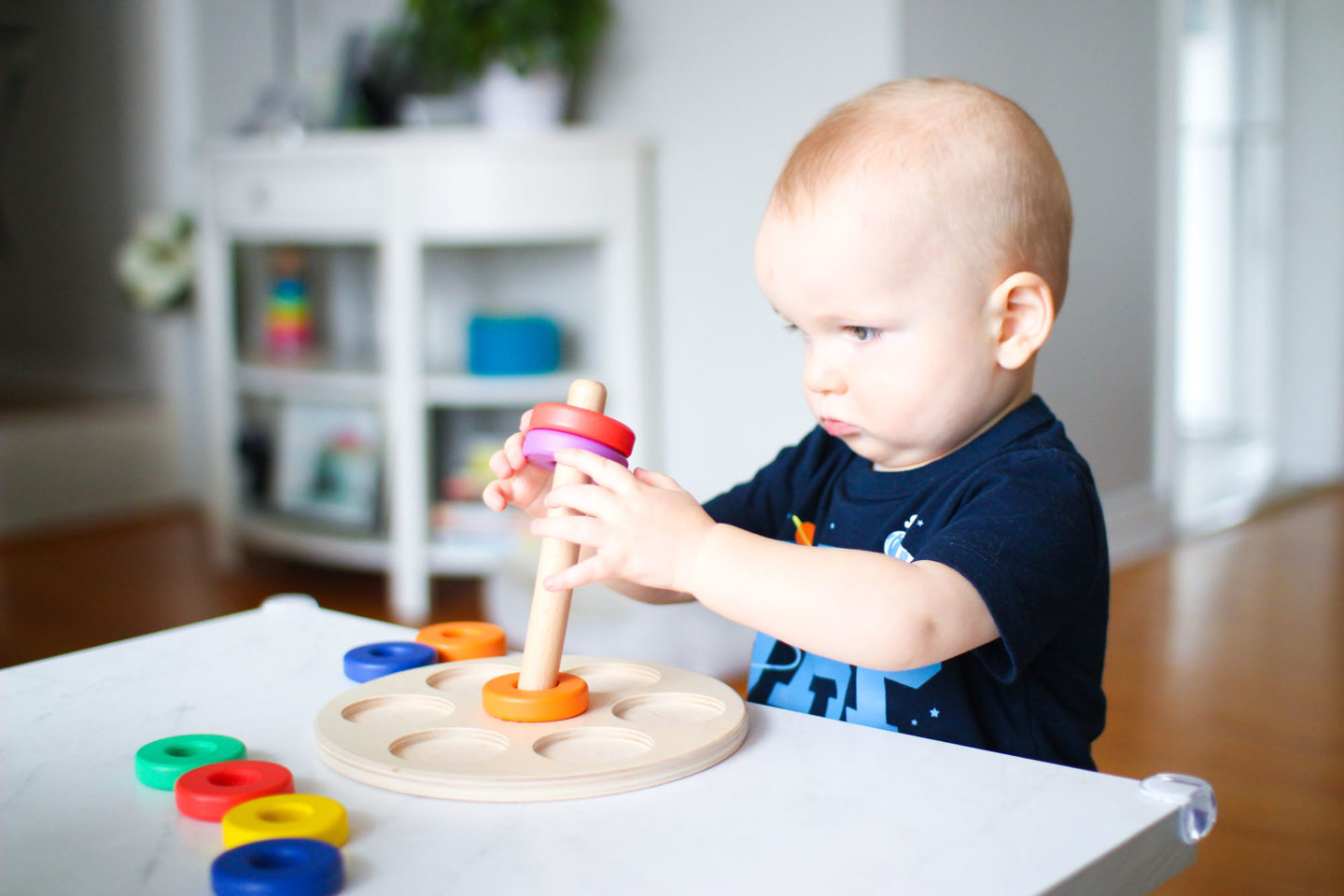 toddler playing with lovevery ring stacker