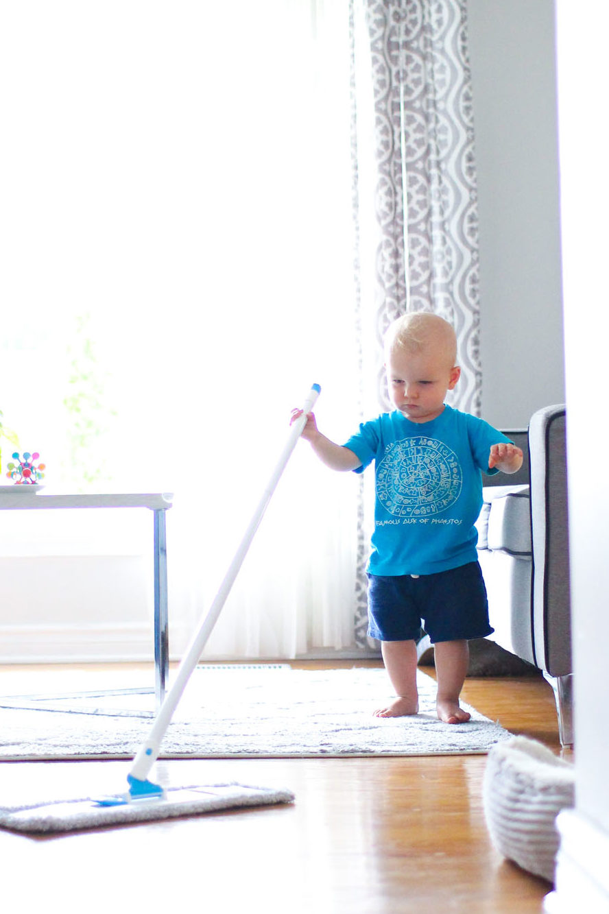 Toddler mopping at home after seeing his mother do the same is an example of Montessori learning.