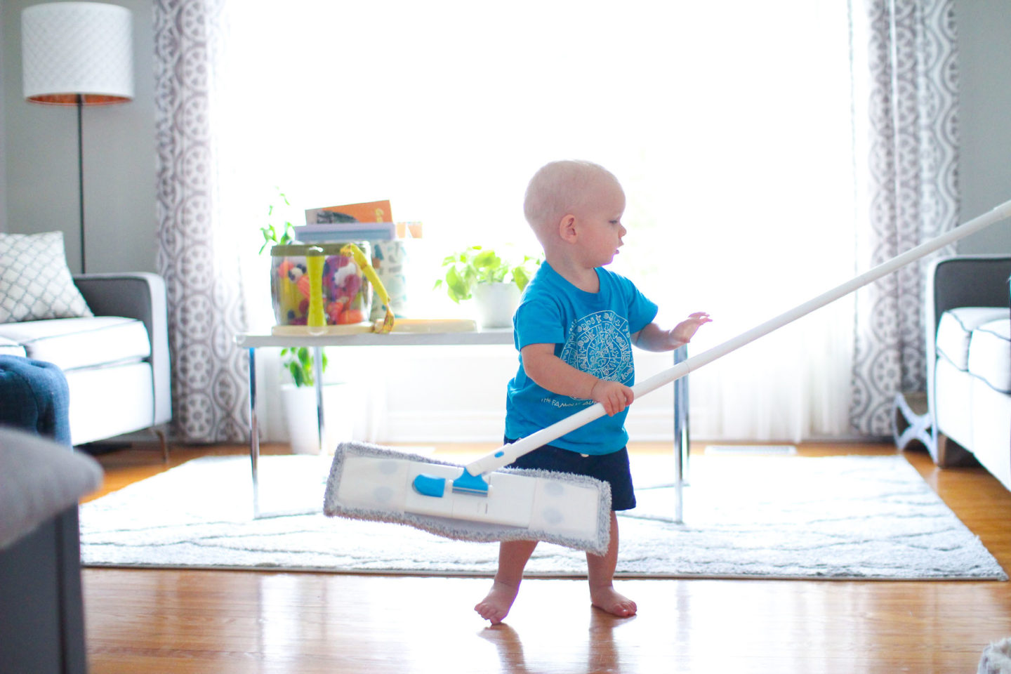 Toddler boy with a mop