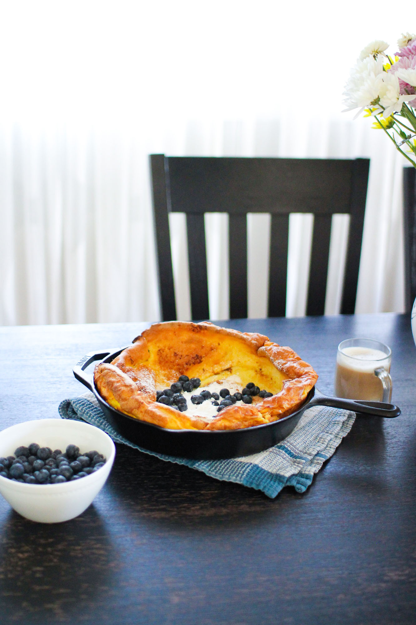 dutch pancake in a cast iron skillet with blueberry topping