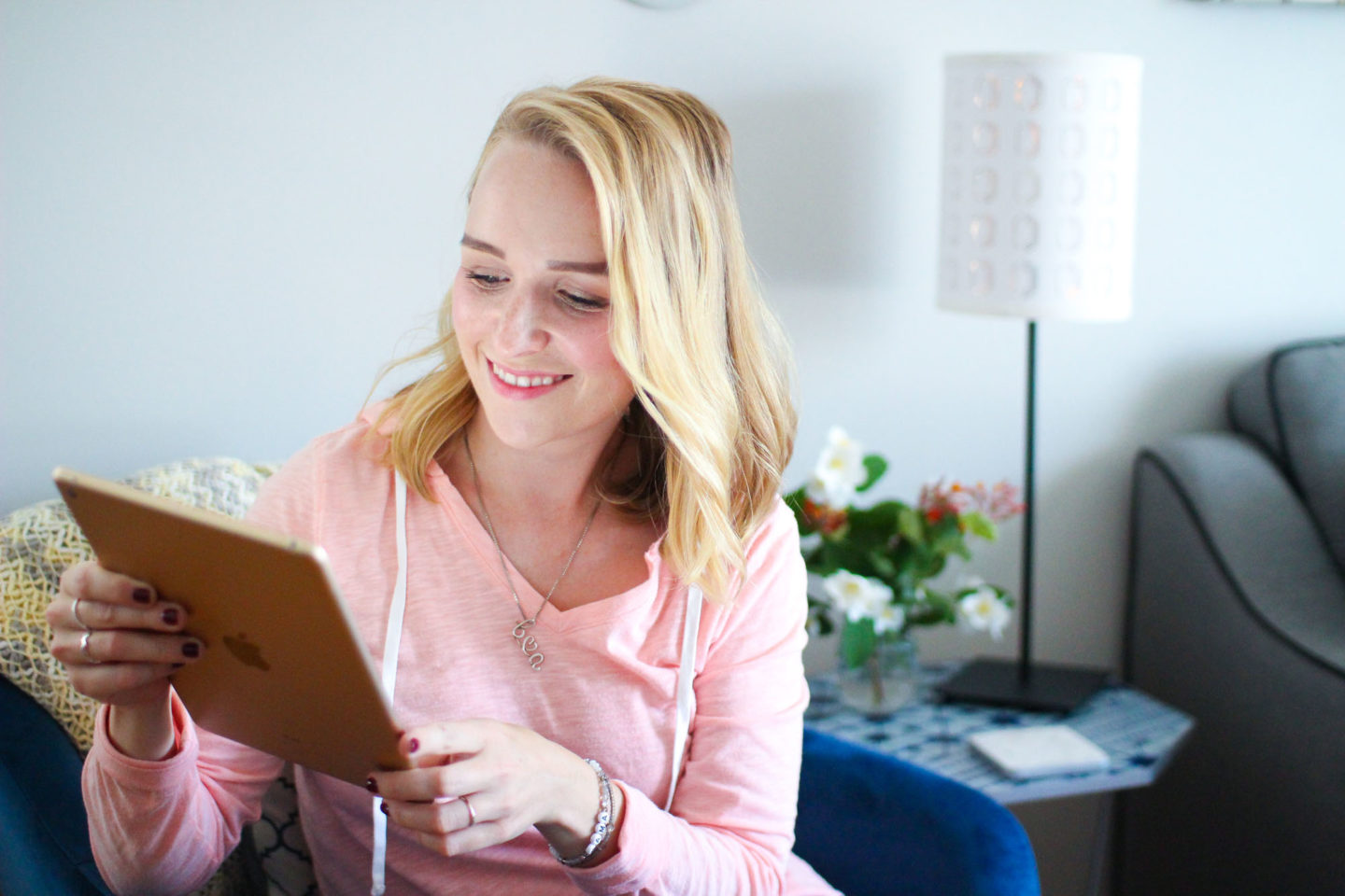 woman sitting using iPad