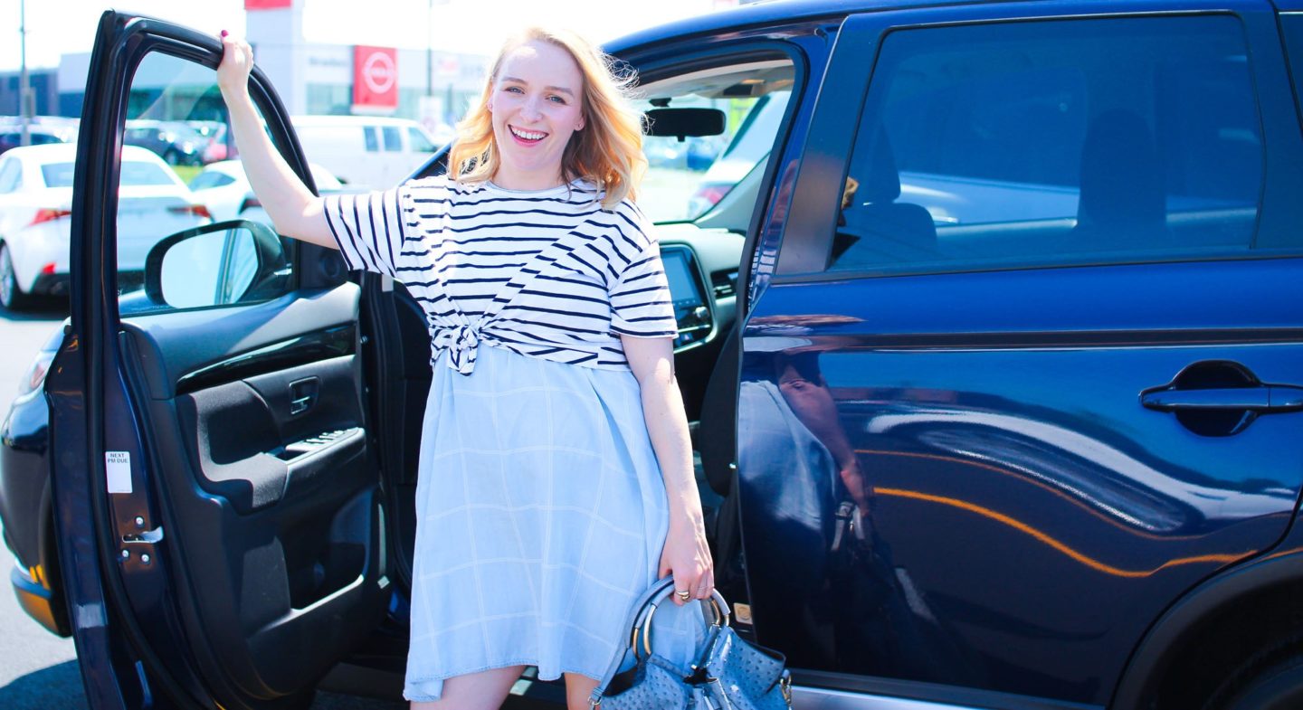 happy woman exiting SUV