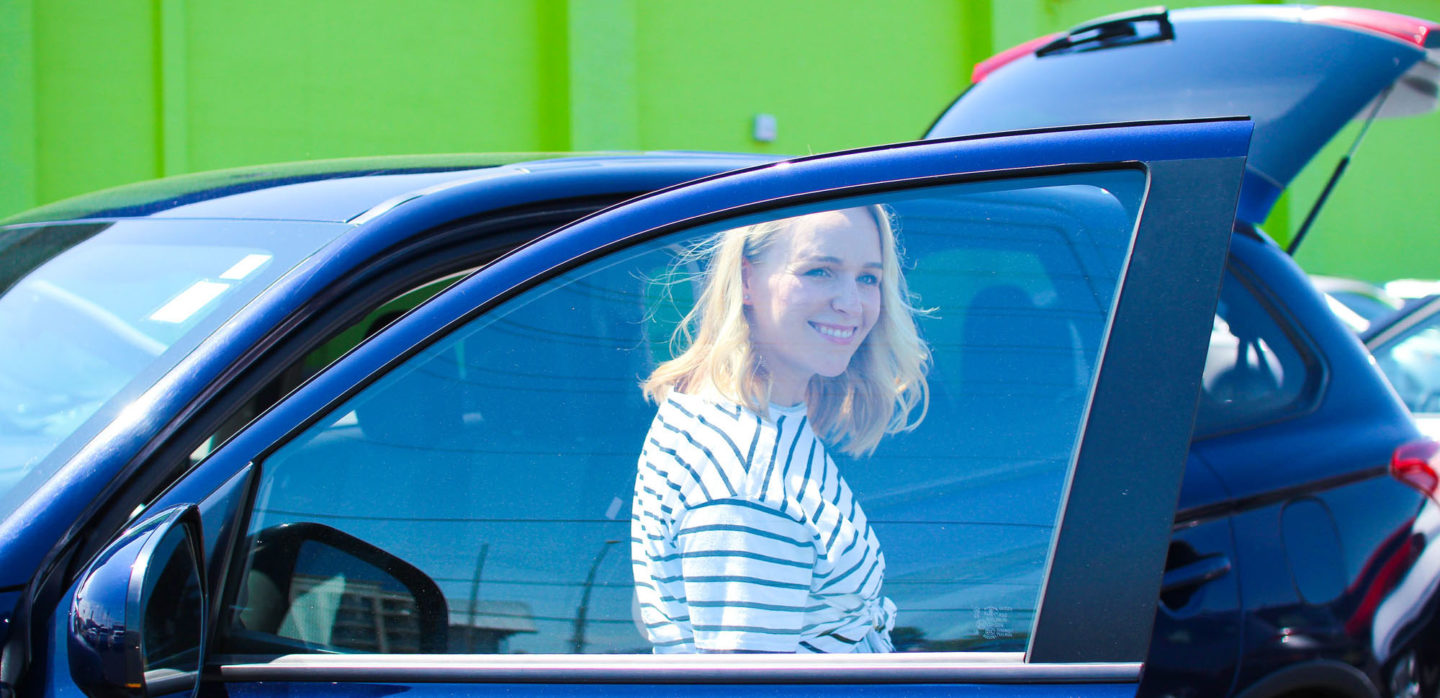 woman stepping out of car door