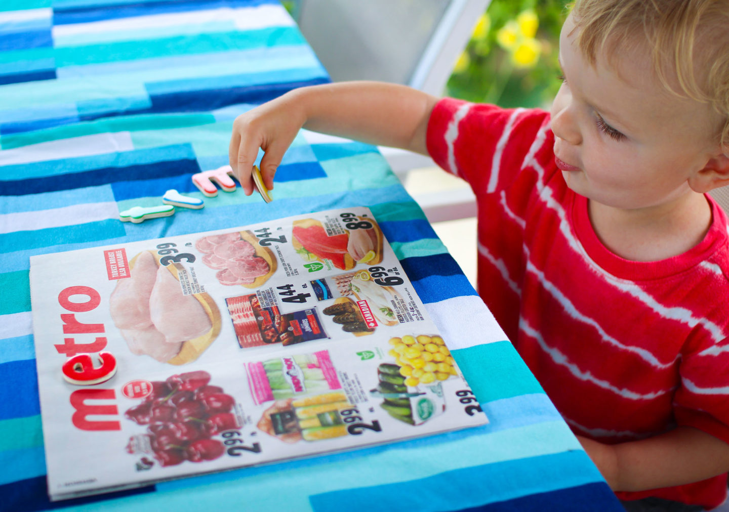 toddler playing with magnets on flyer