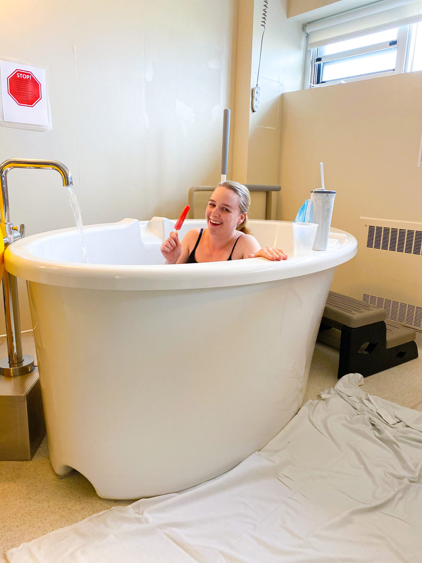 woman in labour eating popsicle in birthing tub